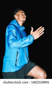 Confident Fit Young African Sports Man Wearing Windbreaker Exercising Outdoors At Night Time, Running At The Beach