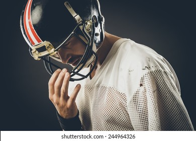 Confident football player with protective helmet posing - Powered by Shutterstock