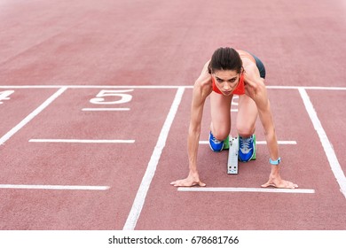 Confident Girl Posing In Blocks To Start Running