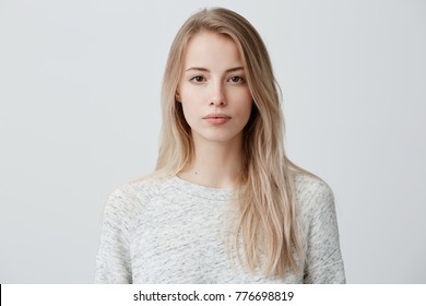 Confident good-looking beautiful woman with blonde dyed hair with healthy pure skin dressed in casual clothes looking seriously at camera. Youth and beauty concept - Shutterstock ID 776698819