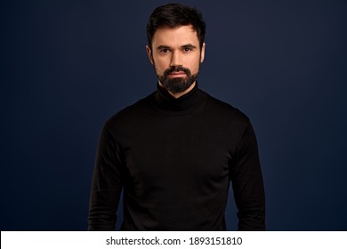 Confident Good-looking Male Entrepreneur In Black High Neck Sweater, Smirk And Self-assured, Standing Assertive. Handsome Macho Man.