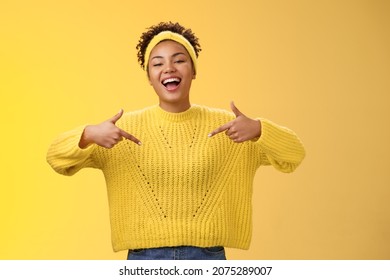 Confident good-looking outgoing black cute girl 20s in sweater headband afro hairstyle pointing heself raise head arrogant laughing bragging telling own personal goals achievements, suggest herself - Shutterstock ID 2075289007