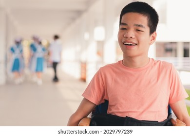 Confident Handicapped Teenager Boy On Wheelchair With Happy Face On Walk Way In Hospital, Smart Disabled Kid Activity To See A Doctor And Push Wheel By Himself,Mental Health Of Diverse People Concept.