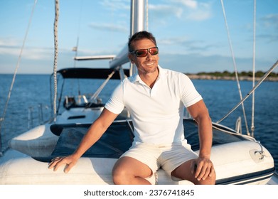 Confident handosme man in sunglasses on a yacht - Powered by Shutterstock