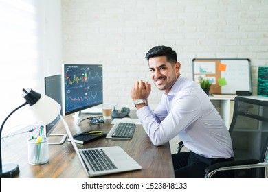 Confident Handsome Male Finance Professional Smiling At Computer Desk While Working From Home