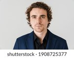 Confident handsome man in jacket posing and looking at camera isolated over white background