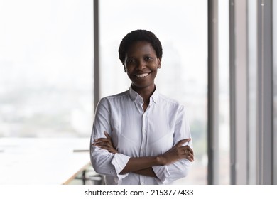 Confident Happy African American Company Owner, Business Leader Woman, Female Executive, CEO Head Shot Portrait. Millennial Black Businesswoman Looking At Camera, Smiling With Folded Arms