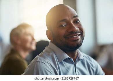 Confident, happy and motivated businessman sitting in an office meeting. Face of a smiling African entrepreneur feeling satisfied with his job choice while attending a presentation or workshop - Shutterstock ID 2188929767
