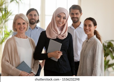 Confident Happy Young Asian Muslim Professional Businesswoman Manager Boss Leader Wear Hijab And Multicultural Office Team People Staff Group Standing Together In Modern Office, Corporate Portrait