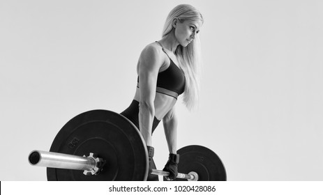 Confident Healthy Young Woman With Barbell Working Out Female Athlete Exercising With Heavy Weights At Gym Bodybuilder Performing Deadlift Exercise With Weight Bar Girl Crossfit Training Routine