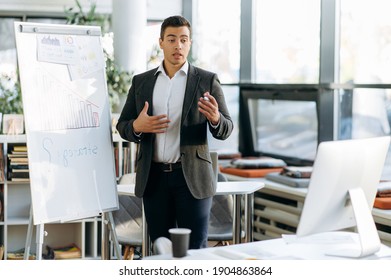 Confident Hispanic Man On Video Briefing Meeting, Talks About New Strategy And Business Plan. Business Leader Discussing Project With Colleagues, Submit Work Report On Video Conference