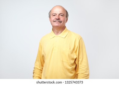 Confident Hispanic Mature Man In Shirt Looking At Camera And Smiling