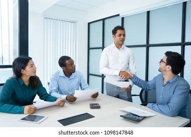 Confident Indian business leader greeting partners - Shutterstock ID 1098147848