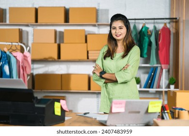 Confident Indian woman portrait entrepreneur at ecommerce fashion outlet or warehouse looking at camera - concept of small business owner, businesswoman and empowerment