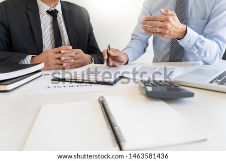 Confident insurance agent broker man holding document and present pointing showing an insurance policy contract form to client  Business Communication Connection Concept