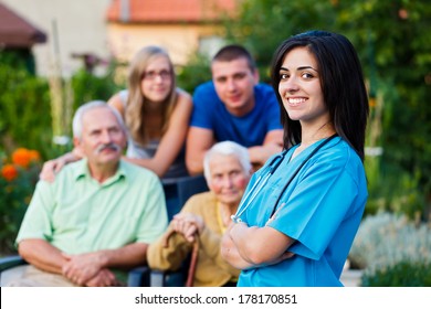 Confident and kind doctor welcoming the family members of the elderly patient.