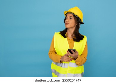 Confident Latina construction engineer with protective gear - Powered by Shutterstock