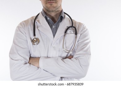 Confident Male Doctor Or Nurse In A Lab Coat And Stethoscope Standing With Folded Arms In A Close Up Cropped Anonymous View Isolated On White