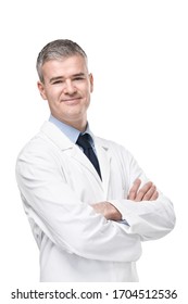 Confident male doctor or pharmacist in white lab coat standing with folded arms smiling at the camera isolated on white
