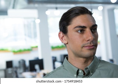 Confident Male Executive Looking Away In The Office