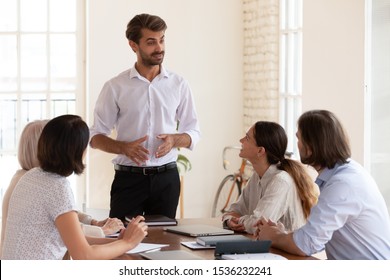 Confident male leader company executive speaking to diverse team people at office briefing explaining business plan to employees work group during corporate training meeting at office boardroom table - Shutterstock ID 1536232241