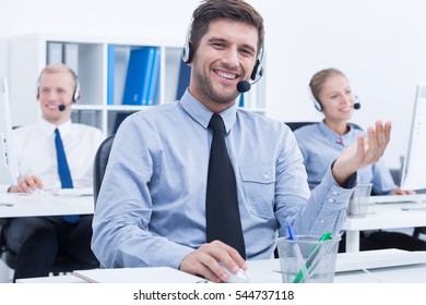 Confident Male Telemarketer During Phone Call At Work