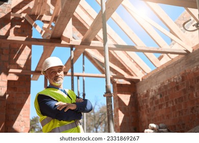 Confident man building constructor standing with folded on chest hands