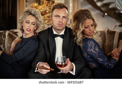 Confident man in the company of two women