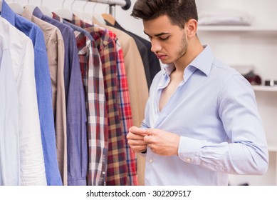 Confident Man Dressing Blue Shirt In Dressing Room.