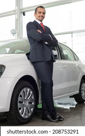 Confident Man In Formalwear Leaning At The Car And Looking At Camera While Standing At Car Dealership