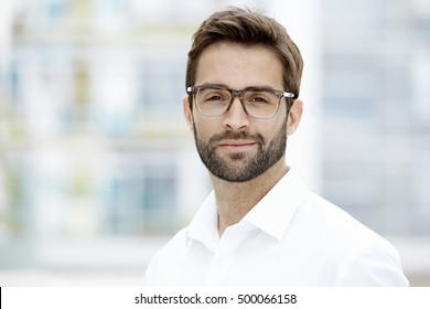 Confident Man In Glasses Looking At Camera