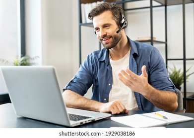 Confident Man With Handsome Stubble, Wearing Headset, Talking In Front Of Computer, Wearing Casual Clothes, Talking At Computer, Discussing Work Process, Gesticulates, Chatting With Partners, Notice