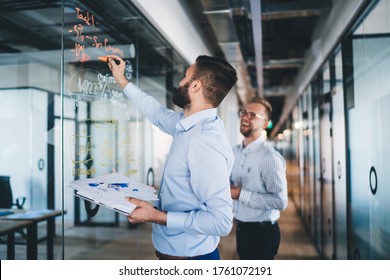 Confident Man Spending Time For Training Business Person Writing Information On Modern Board During Cooperation With Partner Discussing Ideas For Startup Project, Accounting Briefing In Office