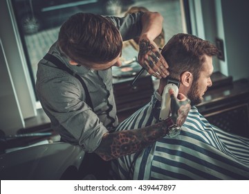 Confident Man Visiting Hairstylist In Barber Shop.