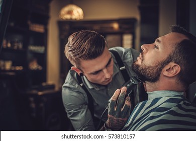 Confident man visiting hairstylist in barber shop