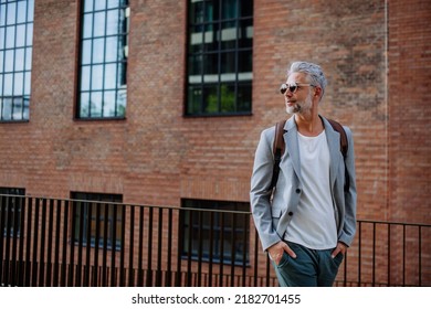 Confident Man Wearing Backpack Walking In Street, Businessman In Casual Clothes In Summer On The Way To Work.