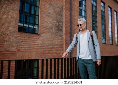 Confident Man Wearing Backpack Walking In Street, Businessman In Casual Clothes In Summer On The Way To Work.