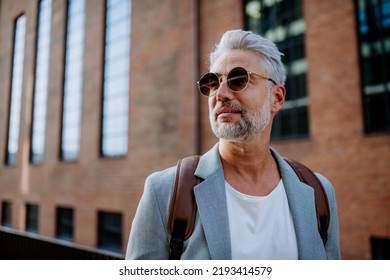 Confident Man Wearing Backpack Walking In Street, Businessman In Casual Clothes In Summer On The Way To Work.