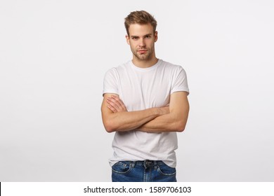 Confident Mature Good-looking, Athletic Blond Guy In White T-shirt, Cross Hands Over Chest And Smiling With Assertive, Determined Expression, Involved In Interesting Conversation, Ready Action