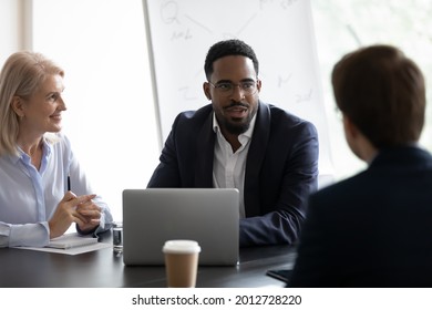 Confident Mentor Giving Lecture To Interns On Corporate Meeting. Business Partners Meeting And Negotiating On Deal. African Team Leader Talking To Employees, Discussing Ideas, Solutions For Project