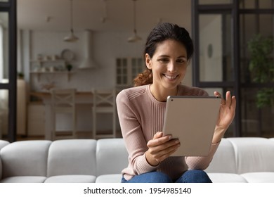 Confident Millennial Latin Woman Hold Tablet Zoom In Image Photo Picture On Screen Enjoy Good Work Of New Web App. Positive Young Female Scroll Text On Pad Read Pleasant Message Email Electronic Book