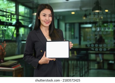 Confident Millennial Woman In Business Suit Holding Digital Tablet, Empty Screen For Your Advertise Text