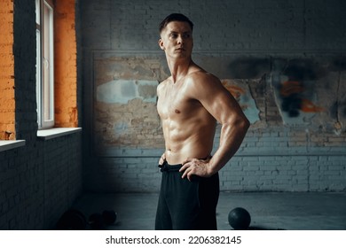 Confident Muscular Man Holding Hands On Hip While Standing In Gym