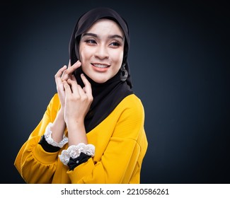 Confident Muslim Woman Wearing Hijab Poses Strongly And Confidently. Women Empowerment And Leadership Concept. Isolated On Dark Background