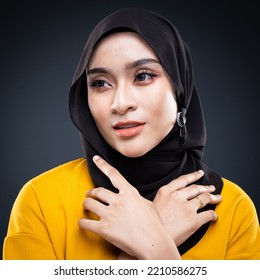 Confident Muslim Woman Wearing Hijab Poses Strongly And Confidently. Women Empowerment And Leadership Concept. Isolated On Dark Background