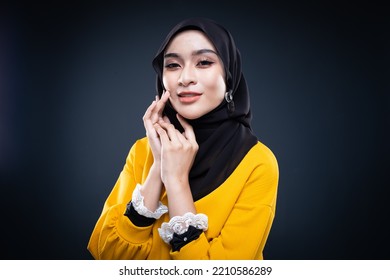 Confident Muslim Woman Wearing Hijab Poses Strongly And Confidently. Women Empowerment And Leadership Concept. Isolated On Dark Background