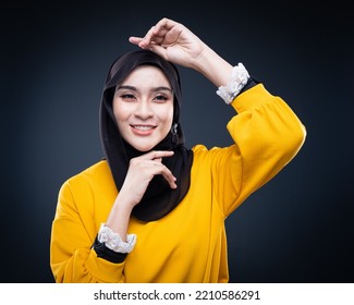 Confident Muslim Woman Wearing Hijab Poses Strongly And Confidently. Women Empowerment And Leadership Concept. Isolated On Dark Background