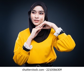 Confident Muslim Woman Wearing Hijab Poses Strongly And Confidently. Women Empowerment And Leadership Concept. Isolated On Dark Background