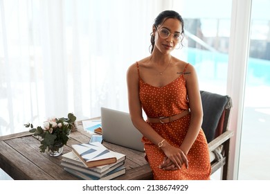 I Am Confident In My Career. Cropped Portrait Of An Attractive Young Businesswoman Sitting On Her Desk In Her Home Office During A Day Off.