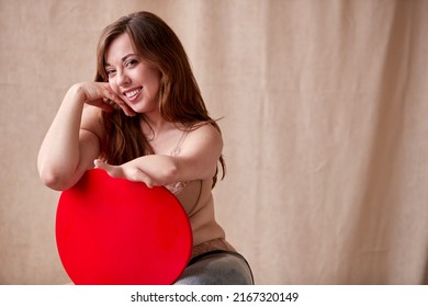 Confident Natural Body Positive Woman With Prosthetic Limb In Underwear Sitting On Chair